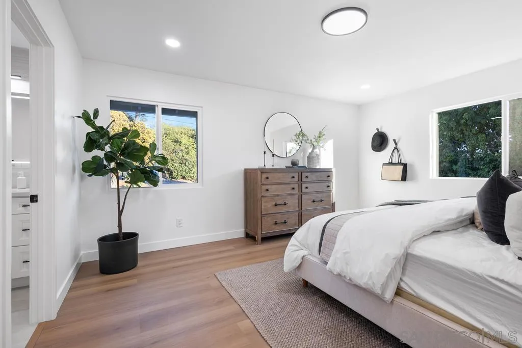 4516 Shade Road La Mesa, CA 91941 - Photo 12 of 33 a bedroom with a bed and a potted plant