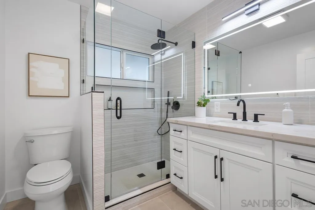 4516 Shade Road La Mesa, CA 91941 - Photo 15 of 33 a bathroom with a shower sink vanity mirror and toilet