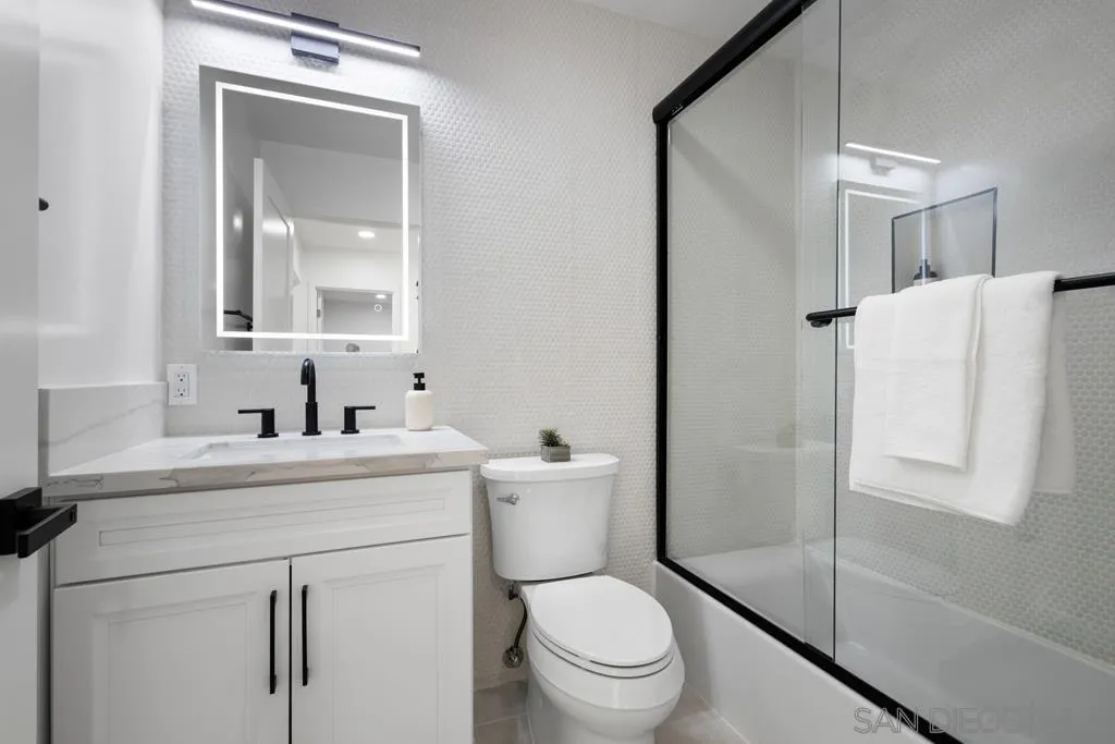 4516 Shade Road La Mesa, CA 91941 - Photo 22 of 33 a bathroom with a toilet sink vanity and mirror