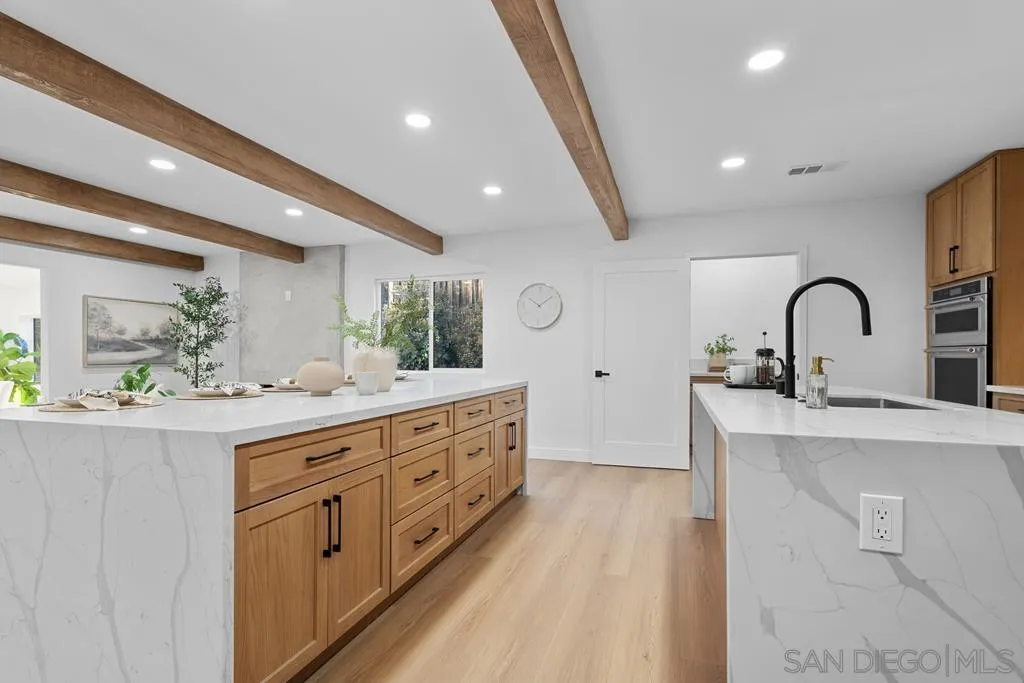 4516 Shade Road La Mesa, CA 91941 - Photo 4 of 33 a kitchen with sink a counter space and cabinets