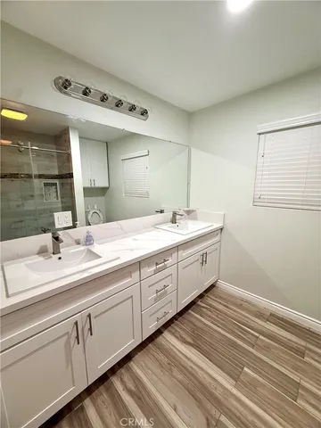 a spacious bathroom with a double vanity sink and mirror
