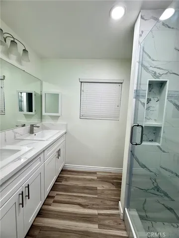 a bathroom with a double vanity sink and mirror