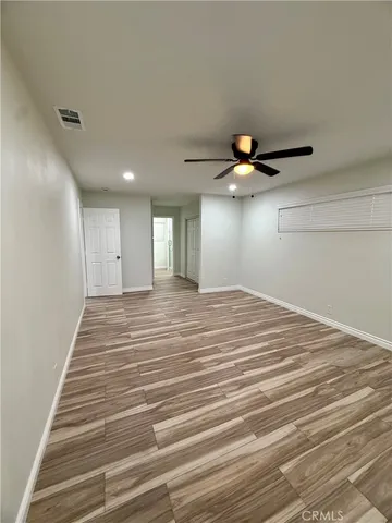 a view of a ceiling fan and wooden floor