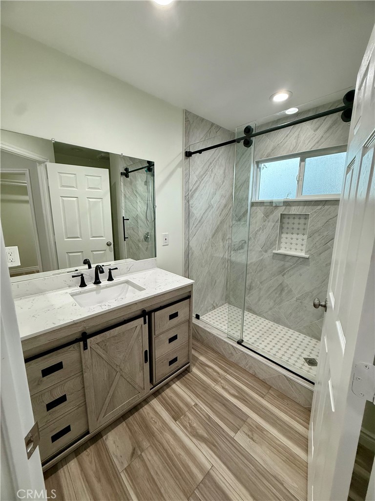 19825 Smith Road Perris, CA 92570 - Photo 8 of 16 a bathroom with a double vanity sink mirror and shower