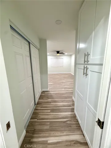 a view of a hallway with wooden floor and staircase