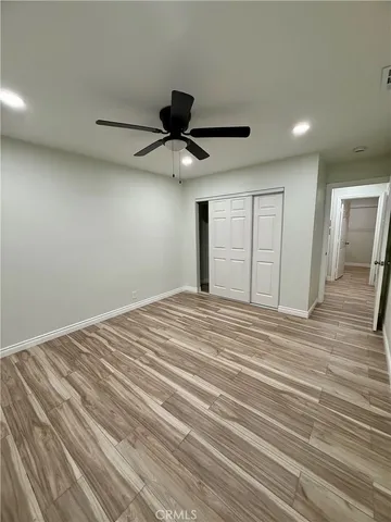 a view of a livingroom with a hall and a ceiling fan