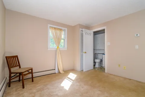 an empty room with windows and closet