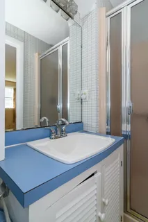 a room with a table chairs and chandelier