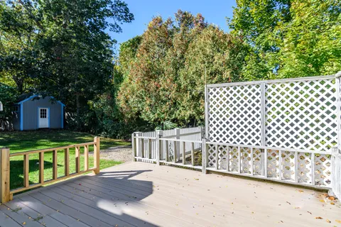 a view of a deck with wooden floor and fence
