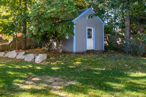 a front view of house with a yard and trees