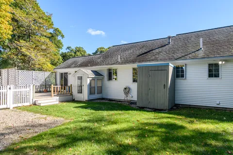 a view of a house with a yard and sitting area