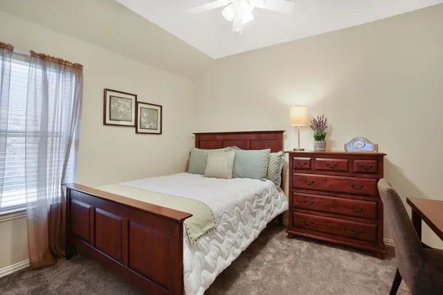 a bedroom with a bed and a dresser