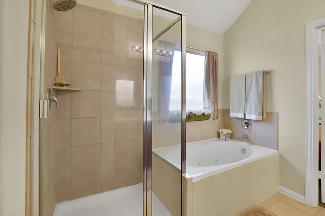 a bathroom with a bathtub and a shower