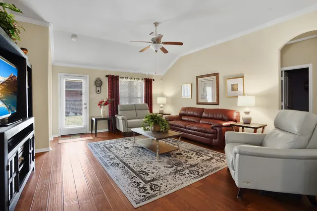 a living room with furniture and a flat screen tv
