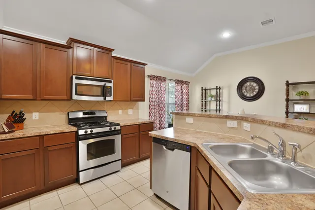 a kitchen with a sink stove and microwave