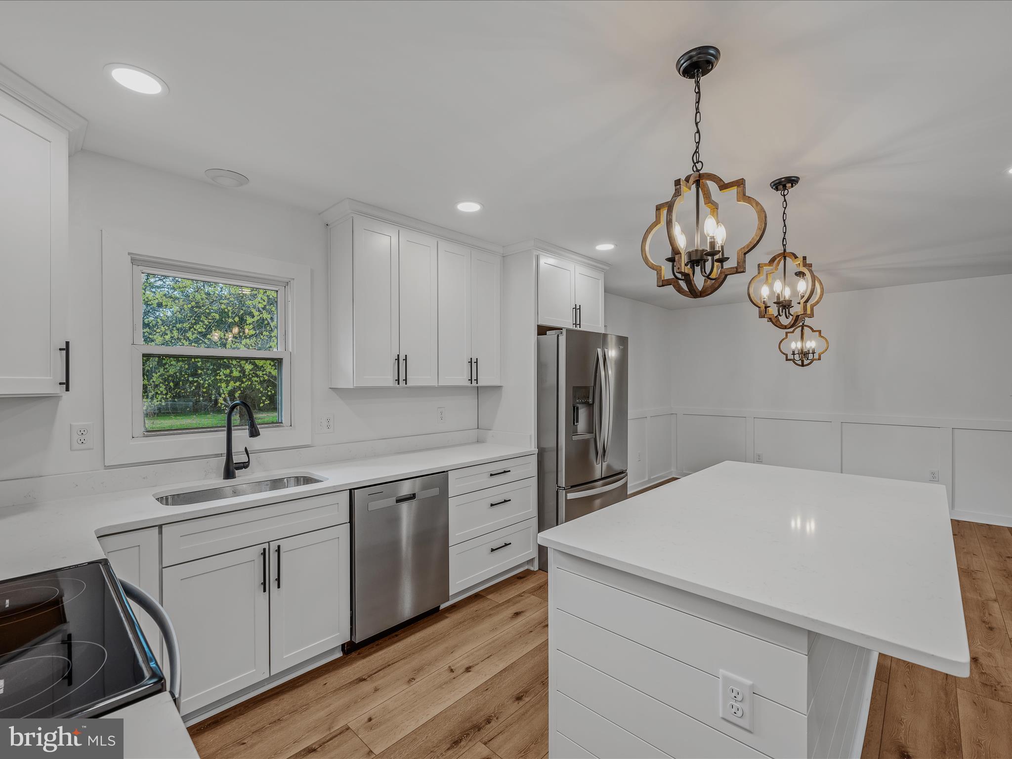 89 Morgan Grove Road Shepherdstown, WV 25443 - Photo 23 of 68 a kitchen with stainless steel appliances a sink dishwasher a refrigerator and white cabinets with wooden floor