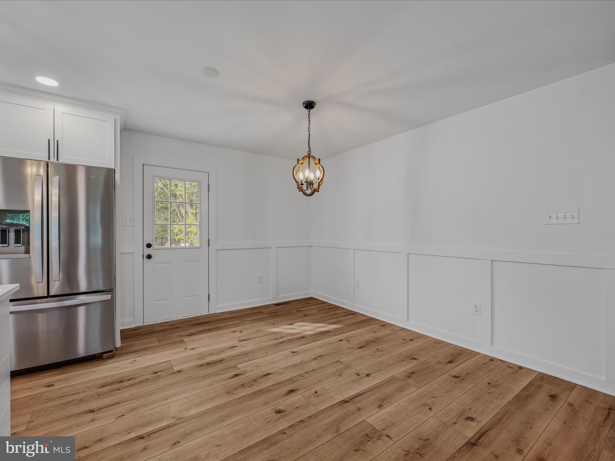 89 Morgan Grove Road Shepherdstown, WV 25443 - Photo 25 of 68 a view of a kitchen with wooden floor and a refrigerator