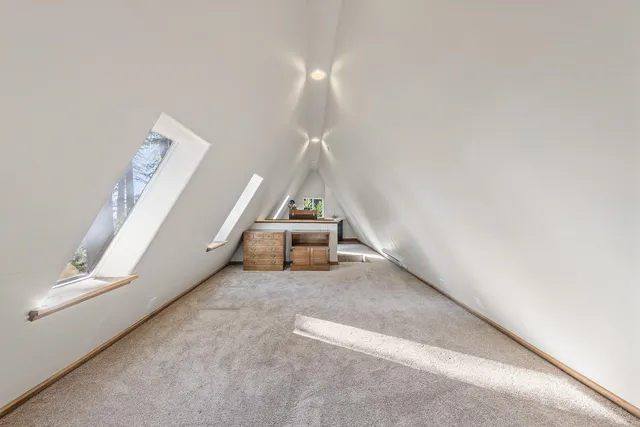 a view of a room with stairs and white walls