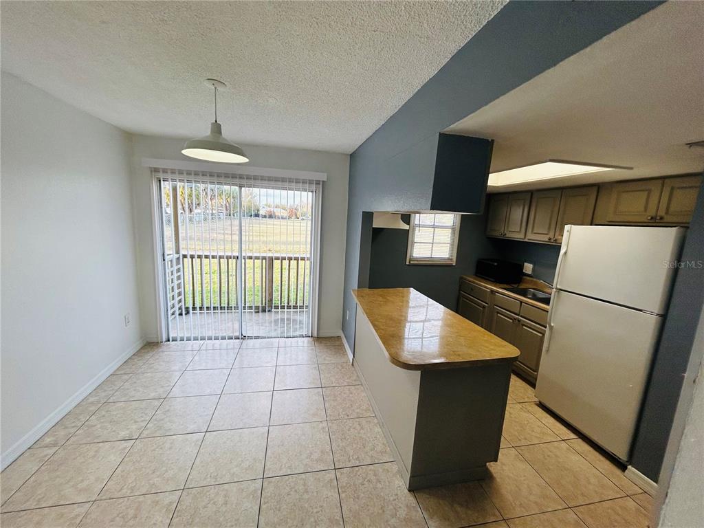 2775 L B McLeod Road, Unit B Orlando, FL 32805 - Photo 2 of 11 a kitchen with stainless steel appliances granite countertop a refrigerator a sink a stove top oven a counter space and cabinets