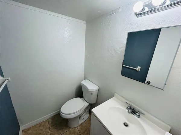 a bathroom with a sink a toilet and mirror