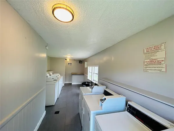 a hallway with a couch and chandelier