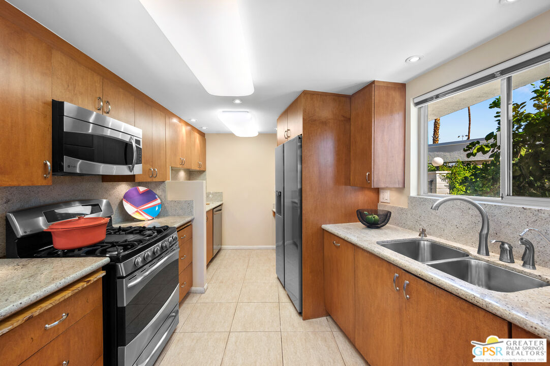 2033 Ramon Road, Unit 2C Palm Springs, CA 92264 - Photo 11 of 35 a kitchen that has a sink and a stove