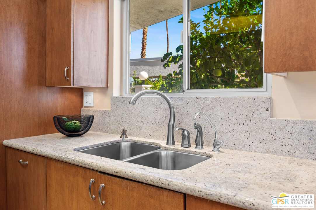 2033 Ramon Road, Unit 2C Palm Springs, CA 92264 - Photo 14 of 35 a kitchen with a sink and a microwave