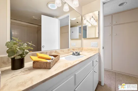 a bathroom with a granite countertop sink and a mirror