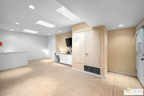 a view of kitchen with furniture and refrigerator