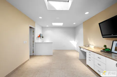 a kitchen with granite countertop a sink and a stove top oven
