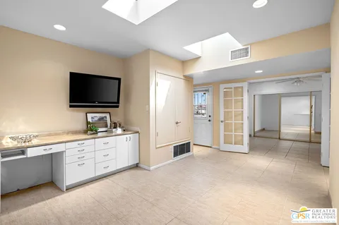 a view of a large kitchen with a sink and a large window