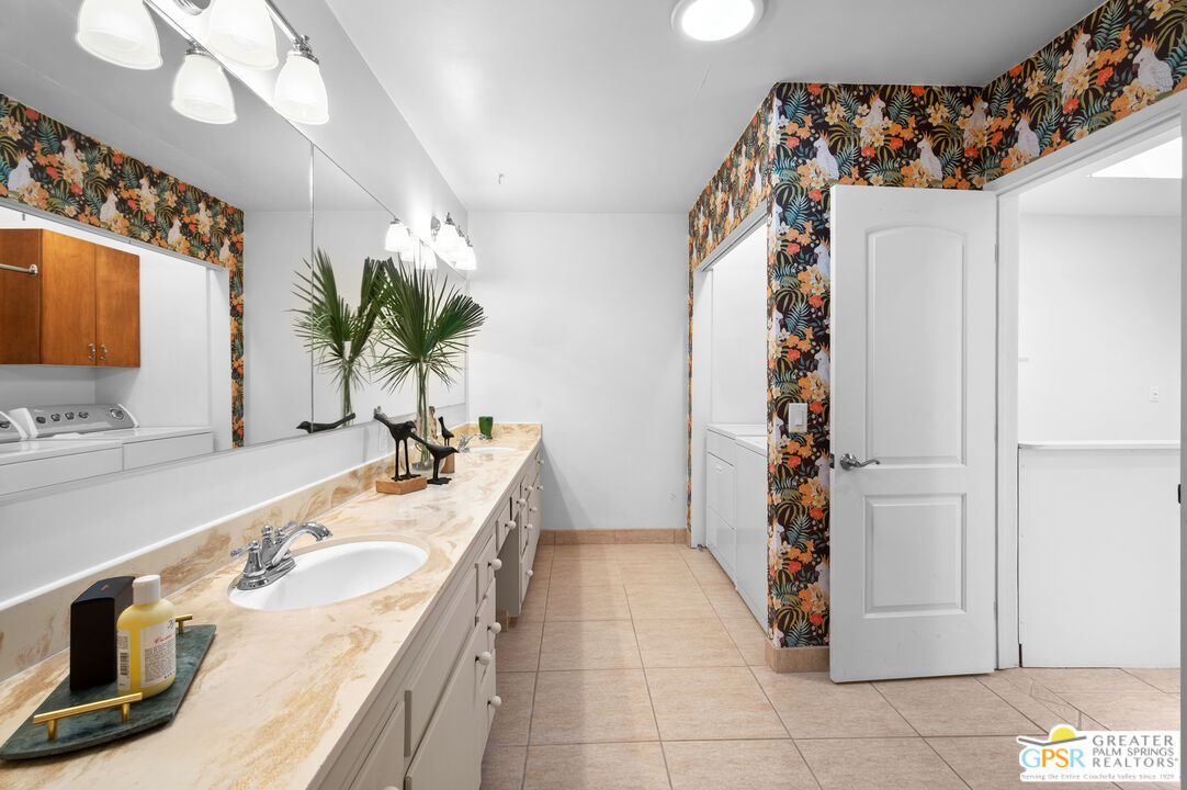 2033 Ramon Road, Unit 2C Palm Springs, CA 92264 - Photo 26 of 35 a spacious bathroom with a granite countertop sink a mirror a vanity and a shower