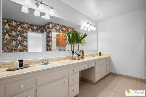 a bathroom with a double vanity sink and a mirror