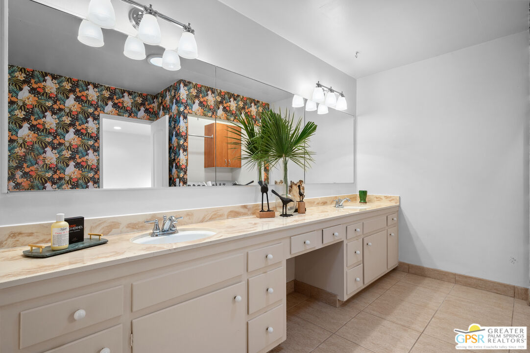 2033 Ramon Road, Unit 2C Palm Springs, CA 92264 - Photo 27 of 35 a bathroom with a double vanity sink and a mirror