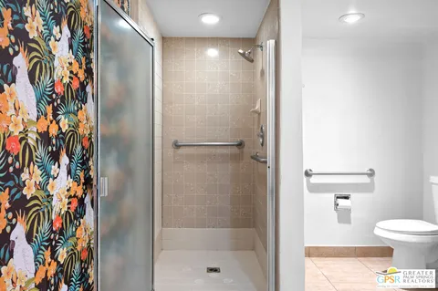 a bathroom with a shower and a toilet