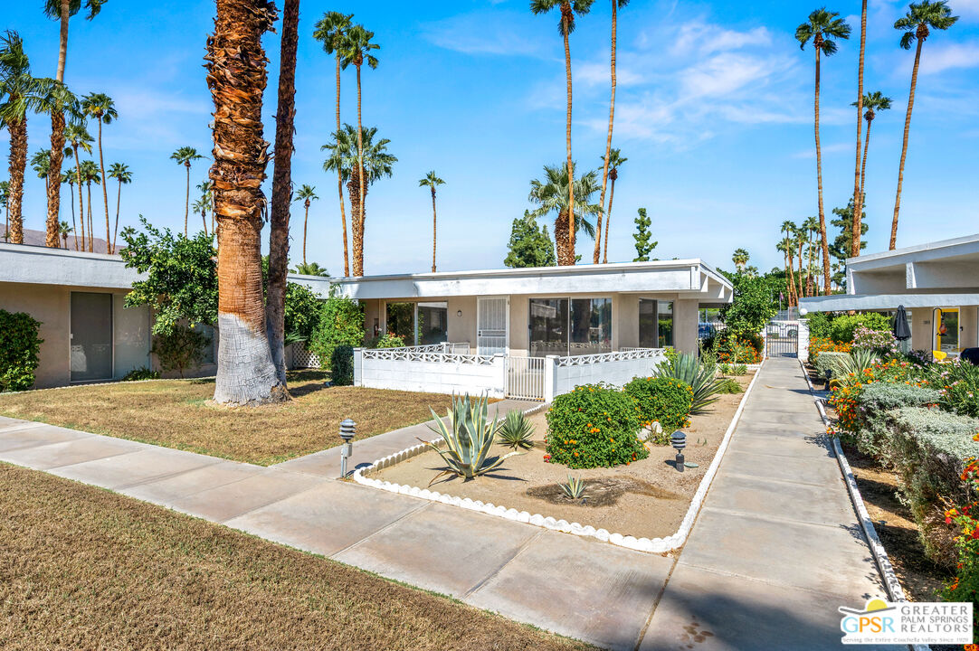 2033 Ramon Road, Unit 2C Palm Springs, CA 92264 - Photo 33 of 35 a front view of a house with a yard and potted plants