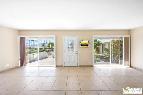 a view of an empty room with glass door