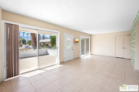 a view of an empty room with glass door