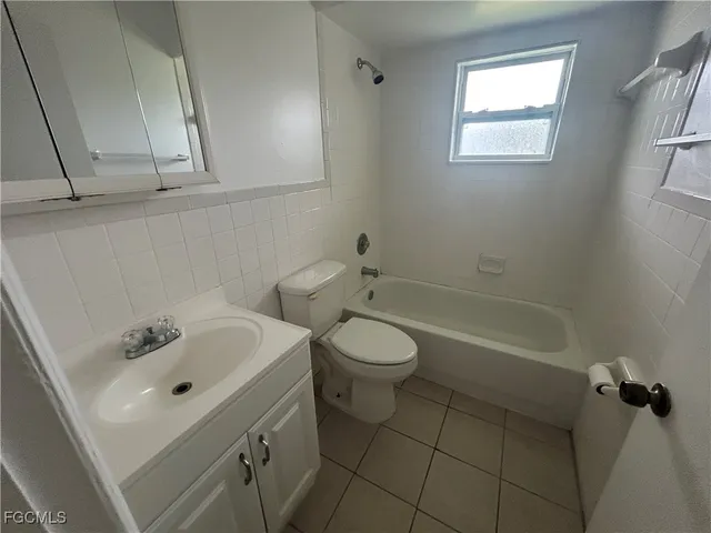 a bathroom with a sink a toilet and bathtub