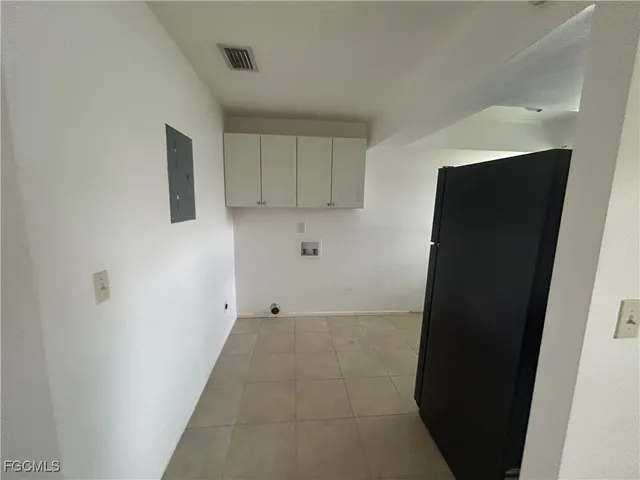 a view of storage and utility room with refrigerator