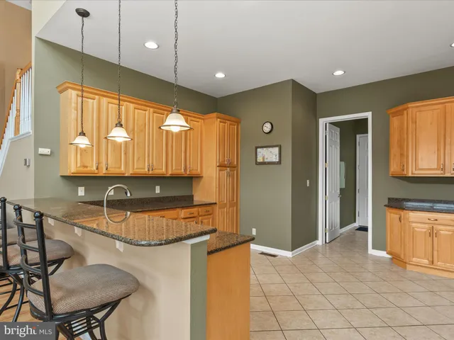 a view of a dining room with furniture a chandelier and wooden floor