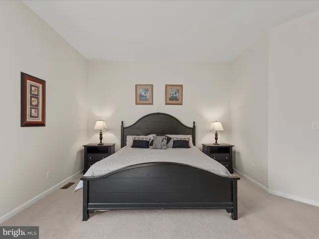 a kitchen with stainless steel appliances kitchen island granite countertop a stove a sink a dining table and chairs with wooden floor