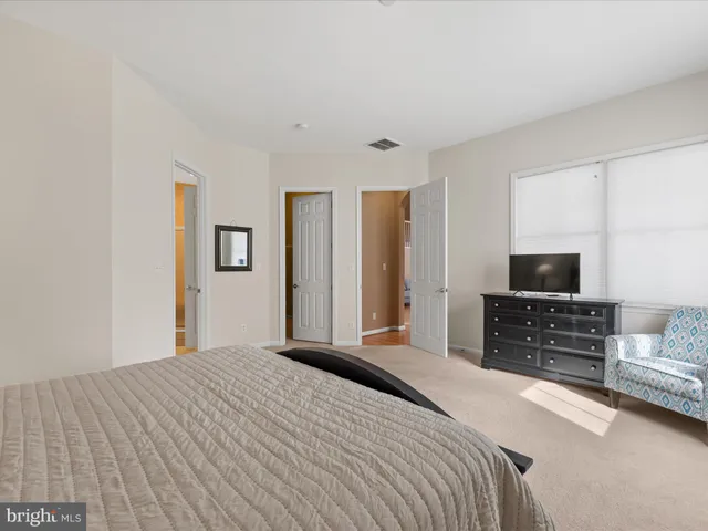 a kitchen with granite countertop a refrigerator stove and cabinets