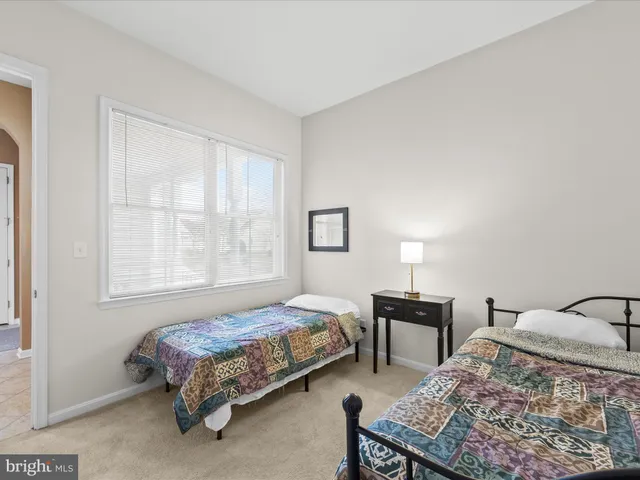 a bedroom with a bed and a lamp