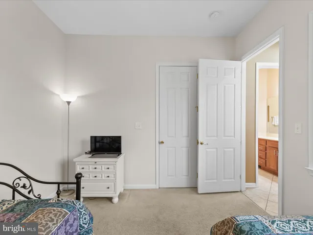 a bedroom with a bed and furniture with wooden floor