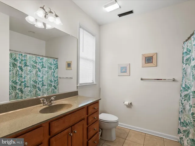 a bedroom with a bed a lamp and a window