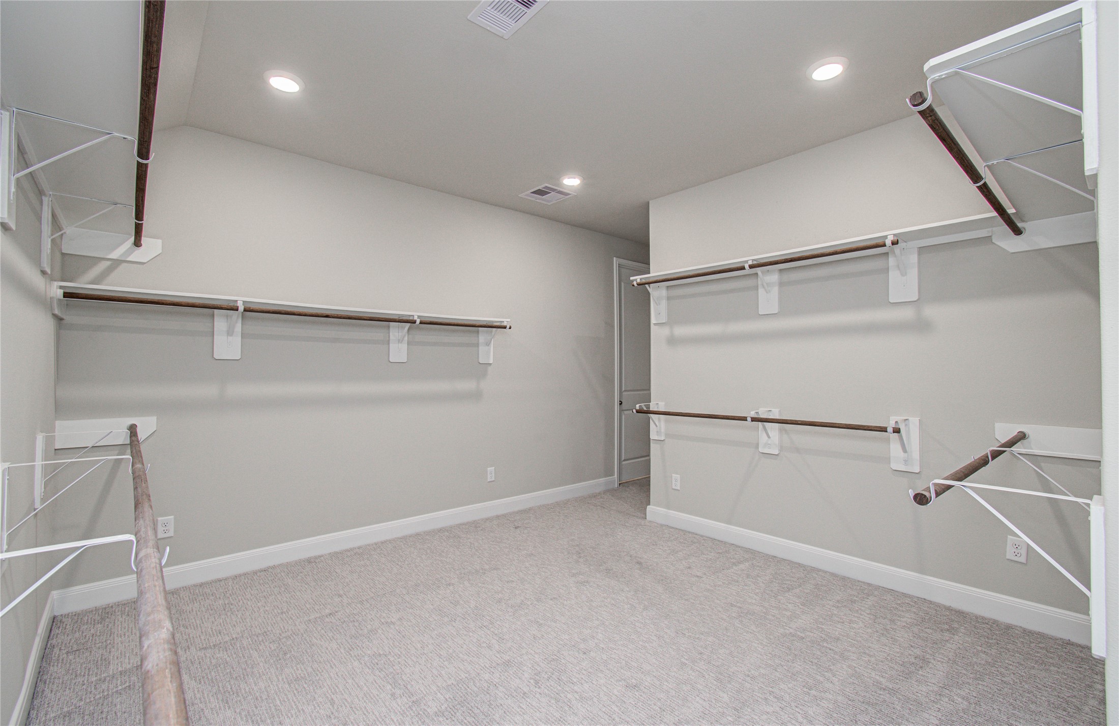 17344 Grand Canyon Road Conroe, TX 77302 - Photo 28 of 49 Spacious walk-in closet with ample hanging space, neutral walls, and carpeted flooring. Ideal for organized storage.