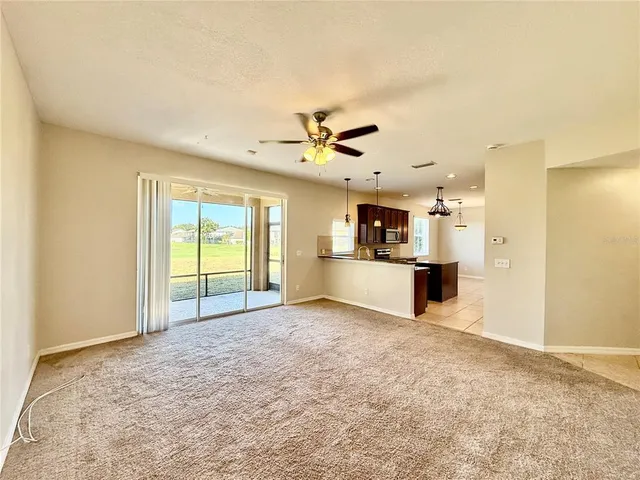 a view of a kitchen with a sink and a refrigerator