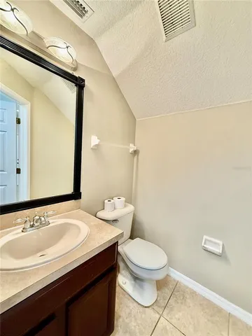 a bathroom with a sink a toilet and mirror