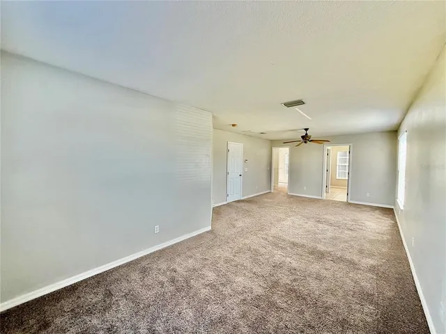 an empty room with a empty space and windows